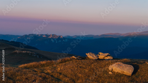 bucegi, Amazing summer sunrise with beautiful orange lights on summit montains photo