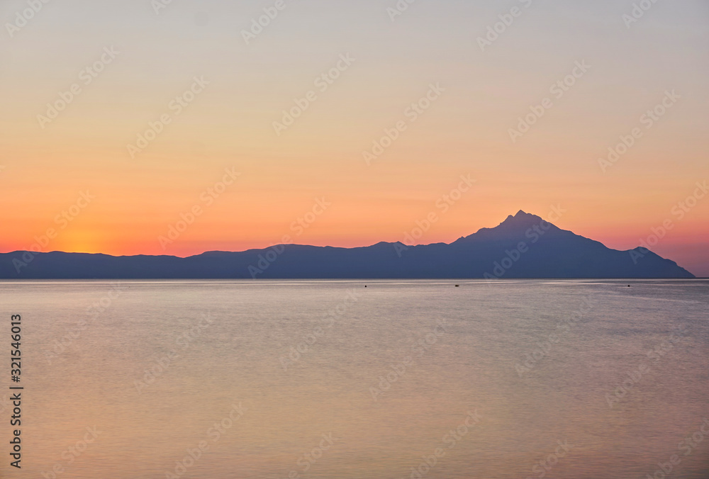 Wonderful sunrise view behind the mountains and next to the sea Wonderful sunrise view behind the mountains and next to the sea