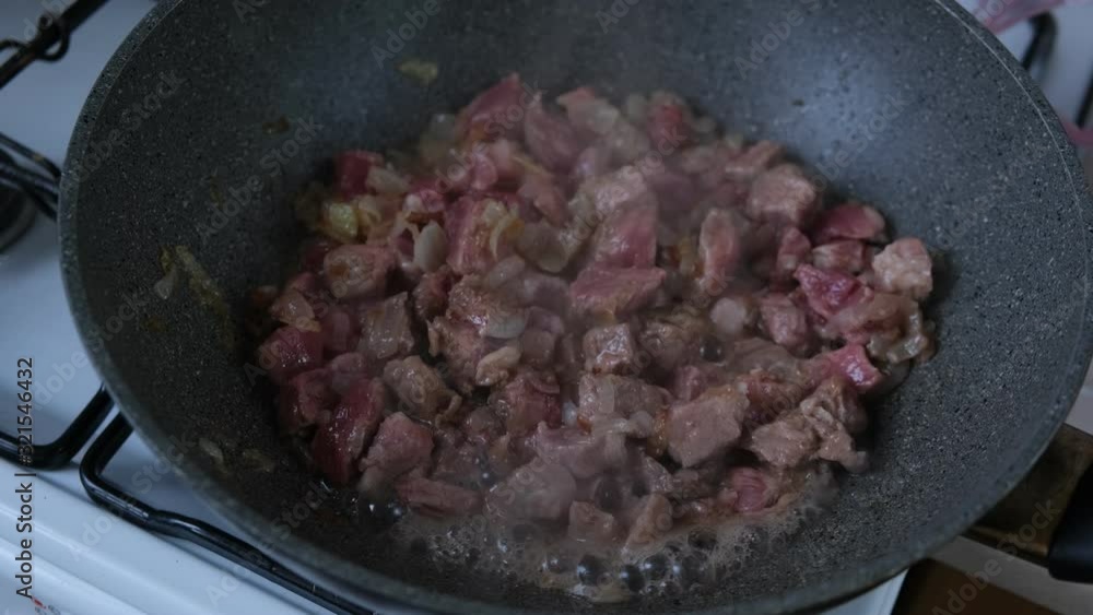 meat is mixed in a wok pan meat is mixed in a wok pan