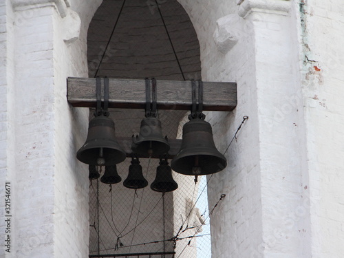 Close up old bells in Bell tower of Georgievskaya church Moscow in Kolomenskoye Park on a winter evening, Slavic religious symbol