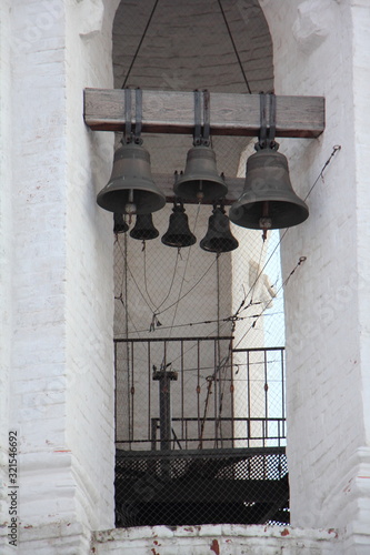 Ancient bells in Bell tower of Georgievskaya church in Kolomenskoye Park Moscow on a winter evening