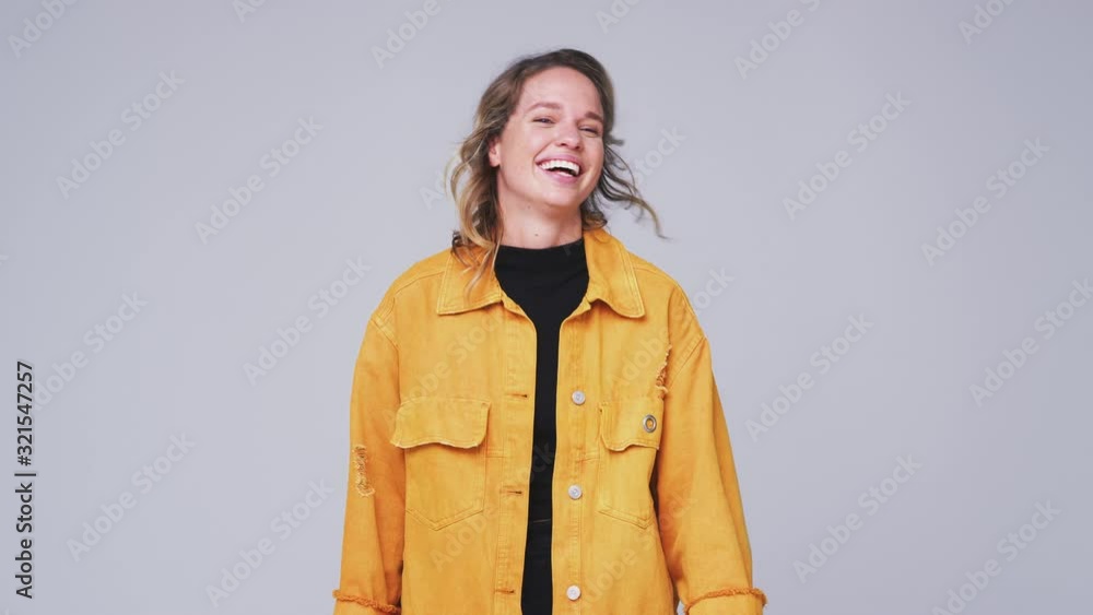 Wide Angle Studio Shot Of Woman Laughing At Camera In Slow Motion Wide Angle Studio Shot Of Woman Laughing At Camera In Slow Motion