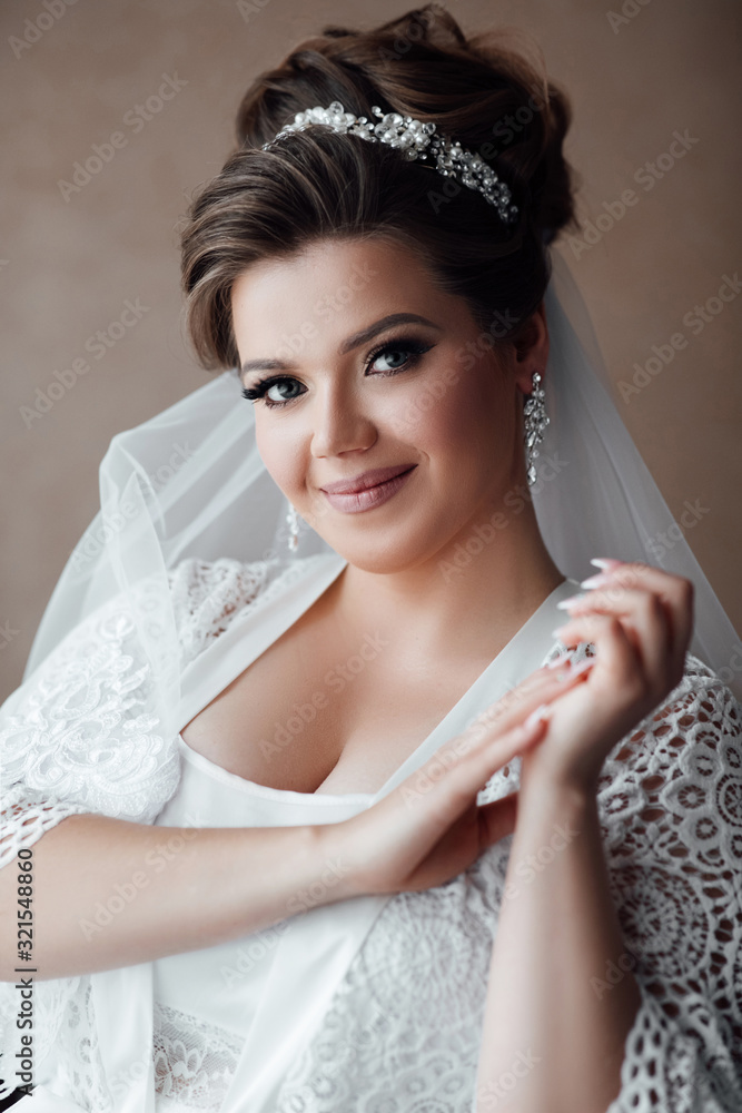 Beautiful bride in robe. Bride with luxurious hair and makeup. Morning of the bride preparations. Sexy bride. Fashion girl gorgeous beauty. Happy girl in robe Beautiful bride in robe. Bride with luxurious hair and makeup. Morning of the bride preparations. Sexy bride. Fashion girl gorgeous beauty. Happy girl in robe