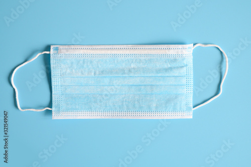 medical mask blue color to cover the mouth and nose for protection from bacteria on a blue background