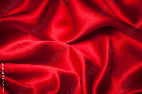 Romantic Valentines Day background of sexy red silk sheets with sensuous folds