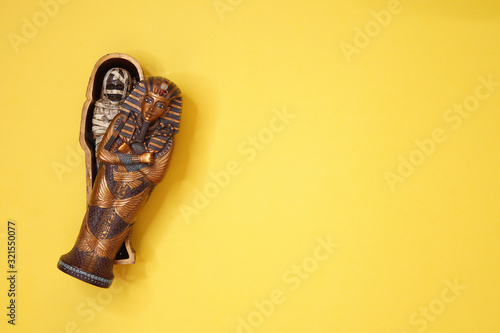 Fényképezés Ancient Egyptian Pharaoh's Sarcophagus With a Mummy Inside and yellow background