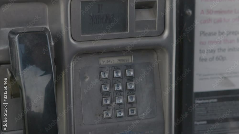 Extreme close up of person using payphone Extreme close up of person using payphone