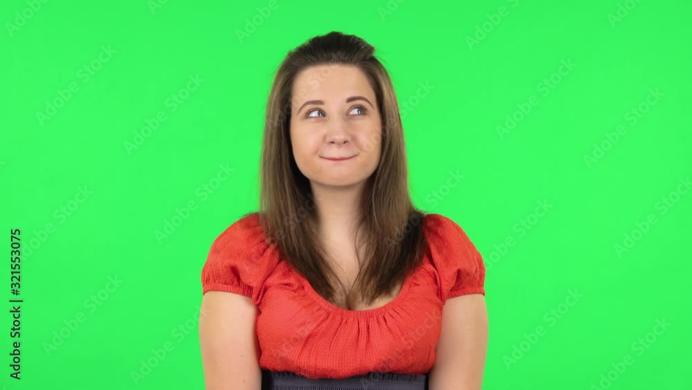 Portrait of cute girl is daydreaming and smiling looking up. Green screen Portrait of cute girl is daydreaming and smiling looking up. Green screen
