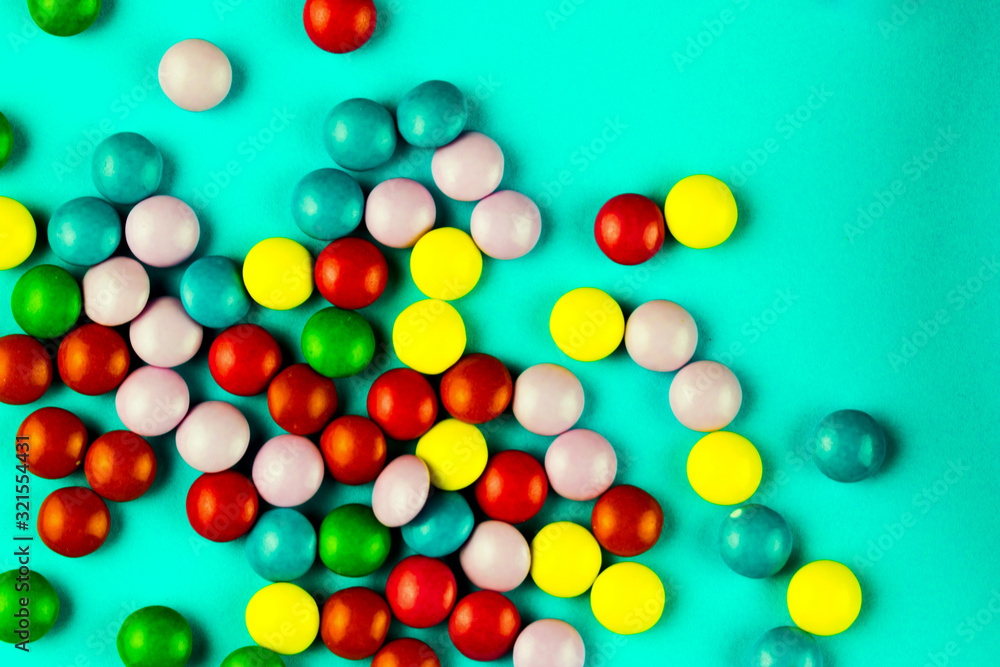 Jelly beans are scattered on a blue background. Jelly beans are scattered on a blue background.