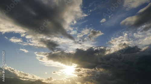 Stormy clouds with sun shining. Dramatic rain clouds.