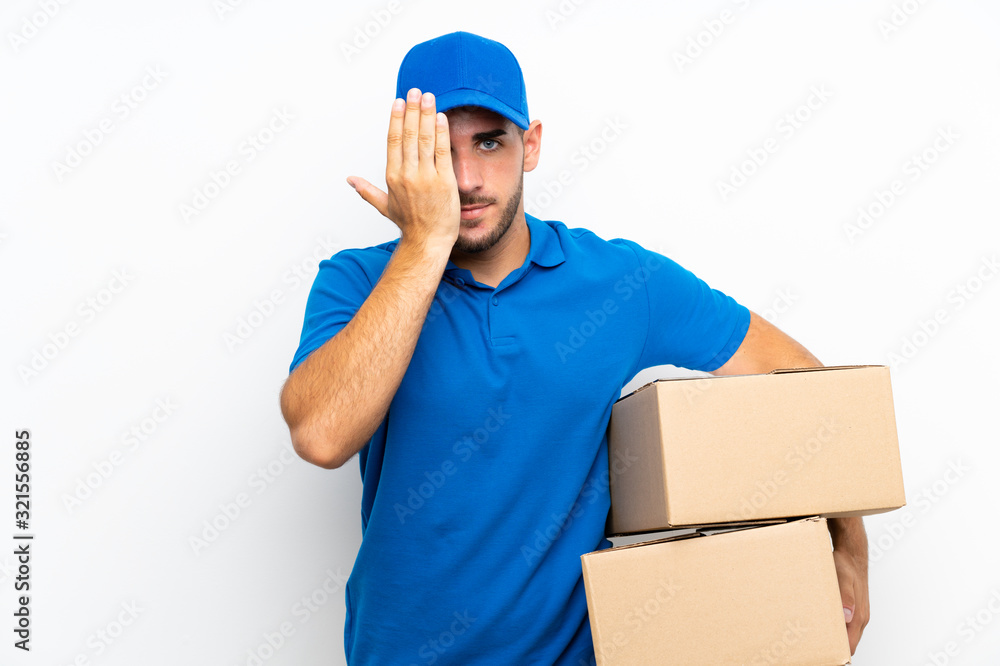 Delivery man over isolated white background covering a eye by hand Delivery man over isolated white background covering a eye by hand
