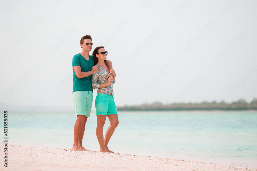 Young couple on white beach during summer vacation. Young couple on white beach during summer vacation.