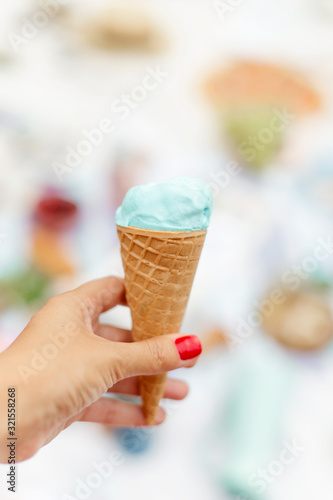 Girl holds a menthol ice cream cone in her hand