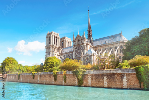 Undamaged east facade of Notre Dame de Paris in Springtime before the fire. Seasonal Spring travel background, panoramic image, panorama of undamaged famous French landmark reflected in river Seine.