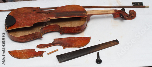 Broken antique red violin for restoration with damage
