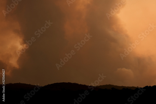 Bush fire smoke at sunset in a valley in The Blue Mountains in Australia