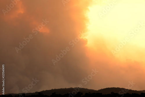 Bush fire smoke at sunset in a valley in The Blue Mountains in Australia