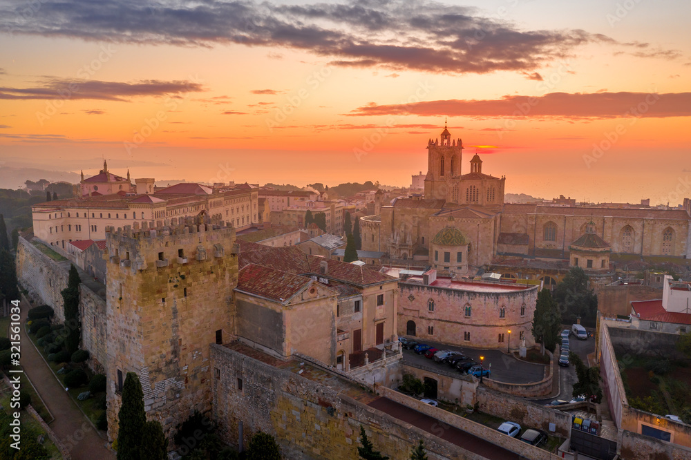 Aerial sunrise view of the medieval walled center of Tarragona in Catalunya Spain with the cathedral, city walls, bastions and towers - obrazy, fototapety, plakaty 
