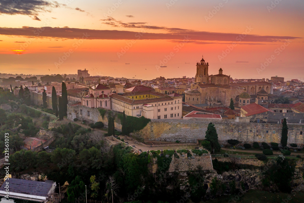 Aerial sunrise view of the medieval walled center of Tarragona in Catalunya Spain with the cathedral, city walls, bastions and towers