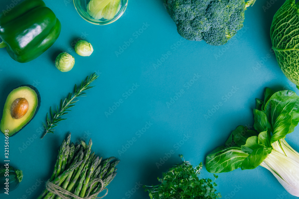 Top view healthy raw vegetables frame with copy space on the blue ...