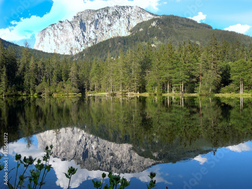 Canvas Print Mountains are reflected in the mountain lake