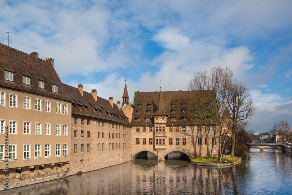 Fototapeta premium Bridge and Hospital, Holy Spirit hospice (Heilig-Geist-Spital) in Nuremberg, Bavaria, Germany