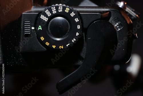 Fotografie Setting wheel for ISO and aperture on an old camera photographed in the studio