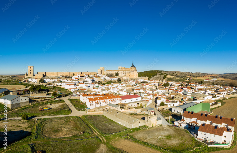 Aerial sunny afternoon view of Ucles castle and monastery historic medieval walled town in Cuenca province Spain