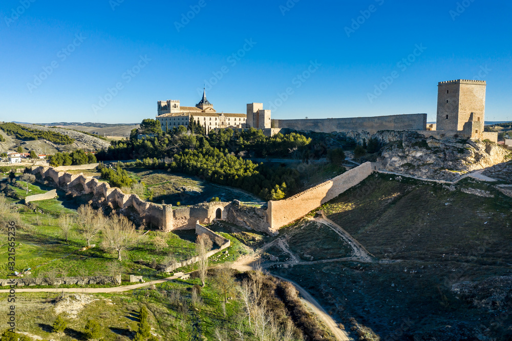 Aerial sunny afternoon view of Ucles castle and monastery historic medieval walled town in Cuenca province Spain