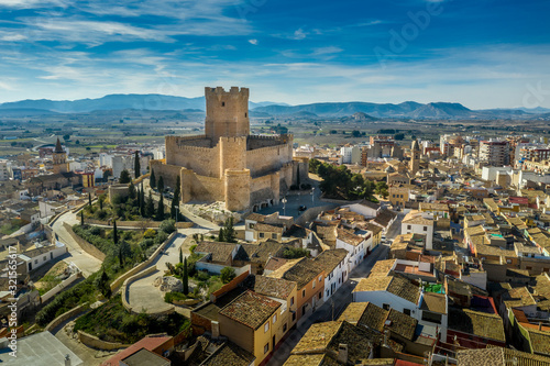 Aerial view of Atalaya castle over Villena Spain. The fortress has concentric plan, with a rectangular barbican forming space in front of the keep.  The external wall has chemin-de-ronde or wall-walk photo
