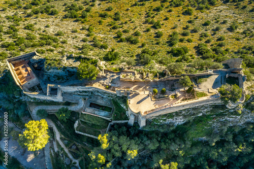 Aerial view of Xativa castle located near Valencia Spain on the ancient roadway  Via Augusta leading from Rome to Cartagena. Two forts connected by walls and curtains running down surrounding the city photo