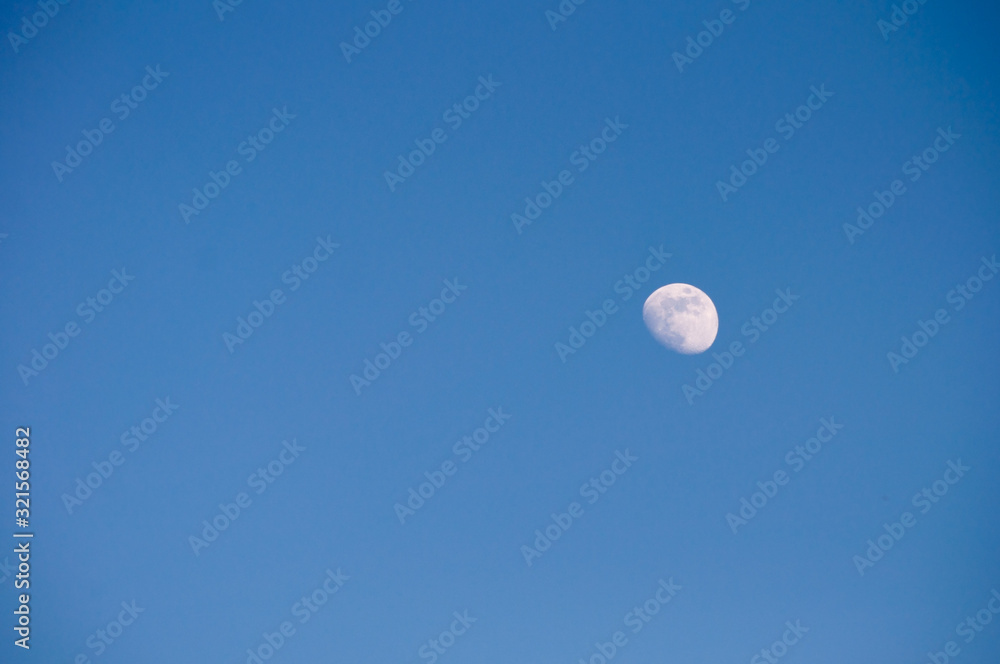 gibbous moon on a blue sky gibbous moon on a blue sky