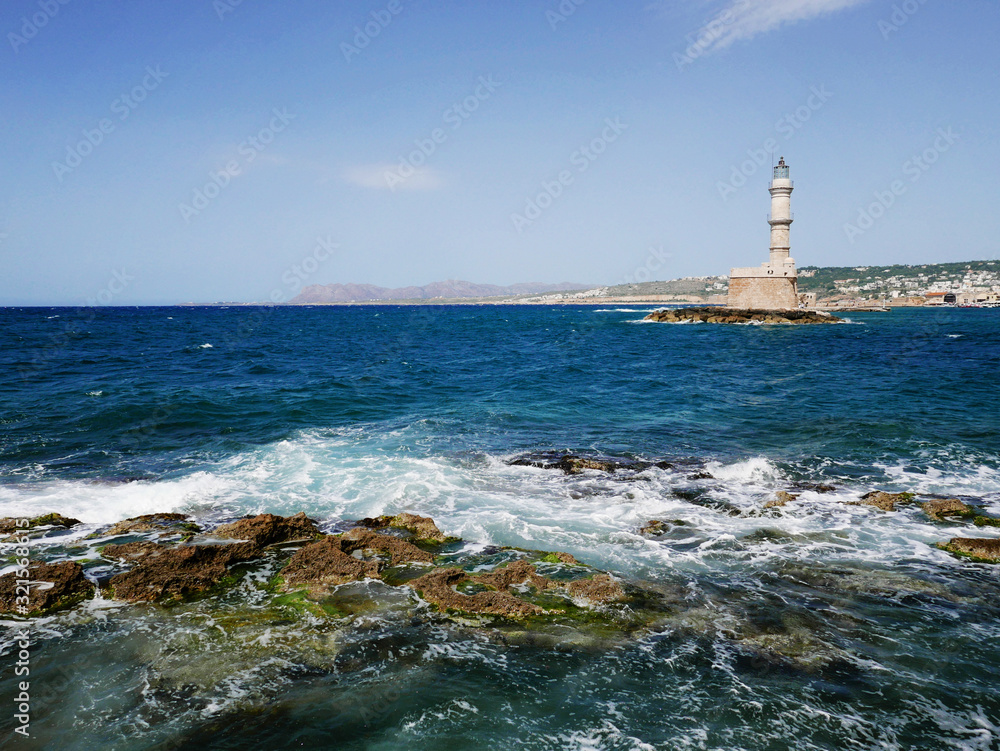 lighthouse on the coast with blue sea, waves and rocks. Beautiful landscape with seaside architecture. Holidays and summer. lighthouse on the coast with blue sea, waves and rocks. Beautiful landscape with seaside architecture. Holidays and summer.