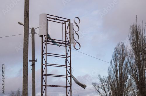 broken advertising banner on gray sky background photo