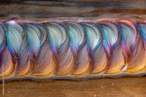 Welding of stainless steel with argon arc welding. Welding TIG. Color welding seam.