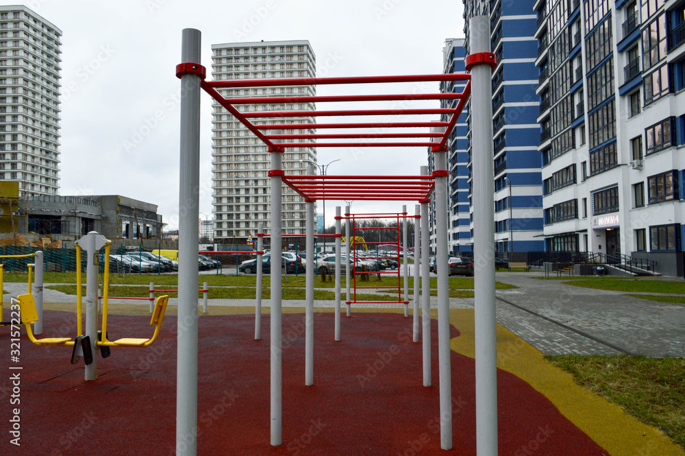 A new modern safe outdoor workout area with exercise equipment for sports in the new district of the city in the courtyard of the new building