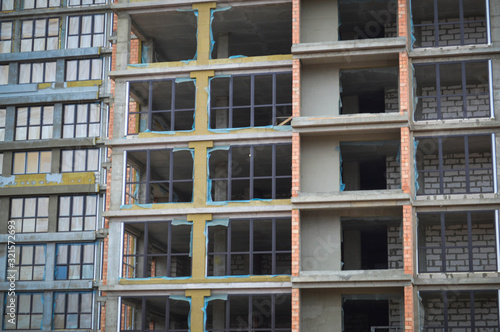 Windows and accessories of a new modern monolithic frame-block house under construction with windows, walls and balconies. Background, texture