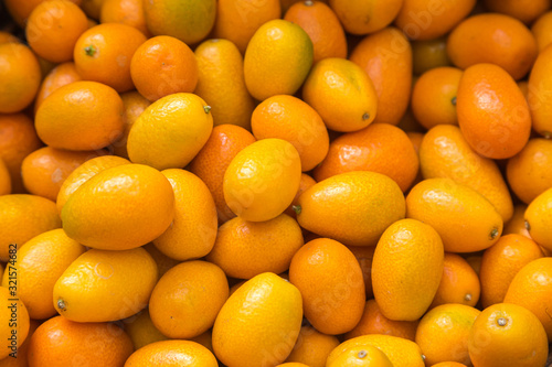 An abundance of kumquats for sale on a market stall