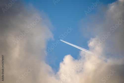 airliner flies through the clouds at high altitude