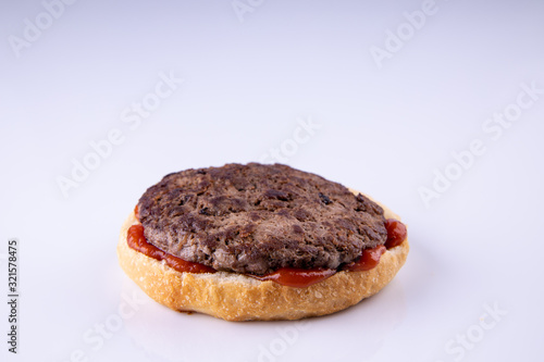  phased assembly of a hamburger on a light background