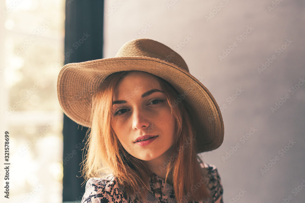 Red-haired girl in a hat on a dark background shows different emotions