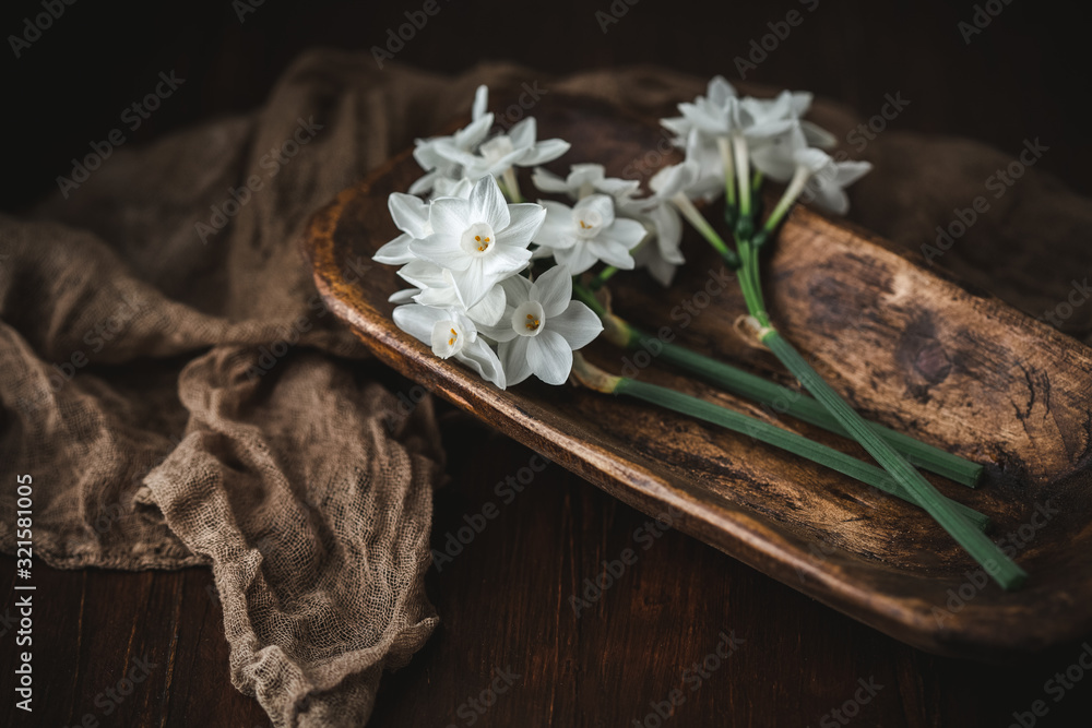Fototapeta premium Freshly Cut Paperwhite Narcissus in Wooden Bowl on Wooden Table