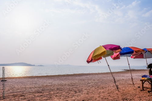 Soft focus Beach umbrella on a sandy beach against the sea background