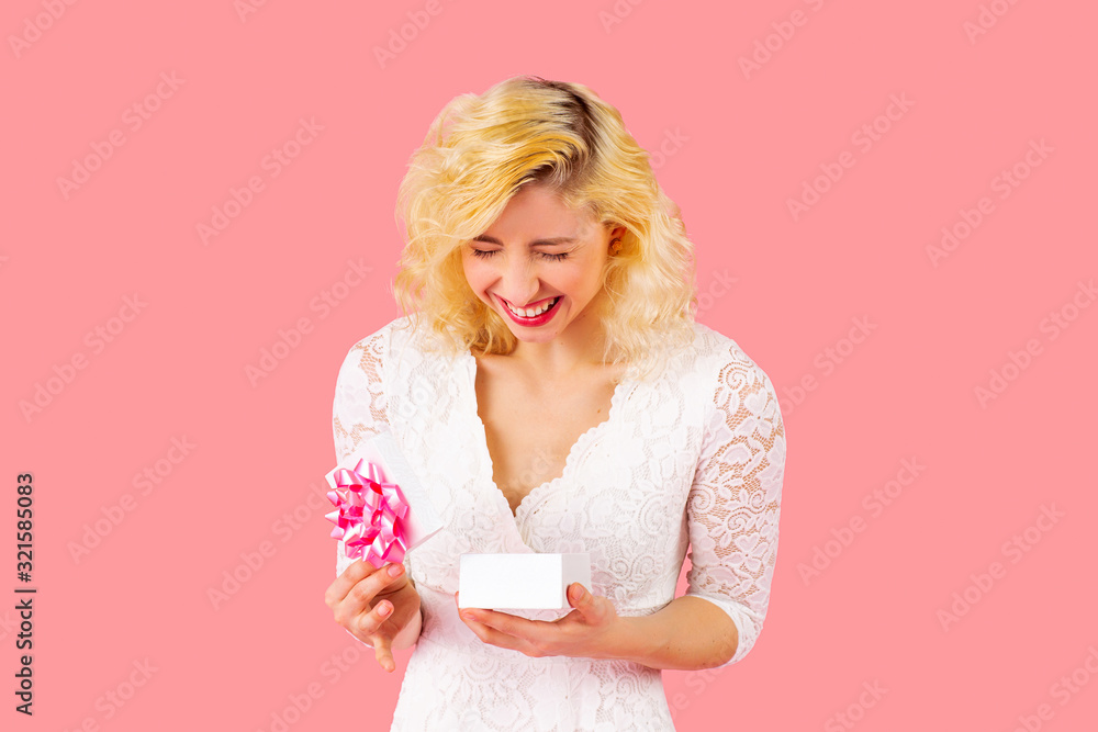 Portrait of young happy woman with very happy reaction to opening a birthday, anniversary or valentineÕs day romantic gift Portrait of young happy woman with very happy reaction to opening a birthday, anniversary or valentineÕs day romantic gift