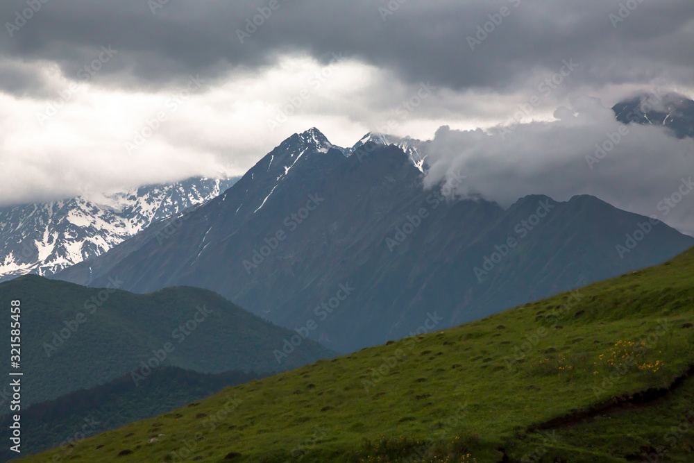 Overcast in mountains. Beautiful mountain rocks in clouds. Landscape of the North Caucasus
