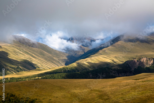 Overcast in mountains. Beautiful mountain rocks in clouds. Landscape of the North Caucasus