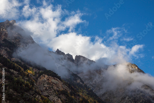 Overcast in mountains. Beautiful mountain rocks in clouds. Landscape of the North Caucasus