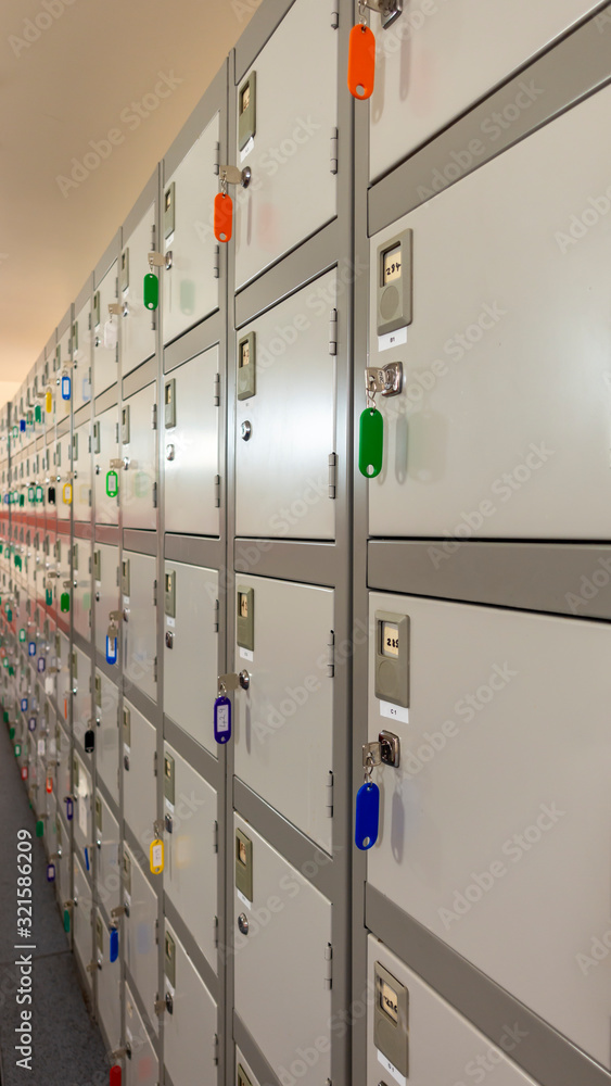 Row of small industrial personal lockers with their keys hanging Row of small industrial personal lockers with their keys hanging