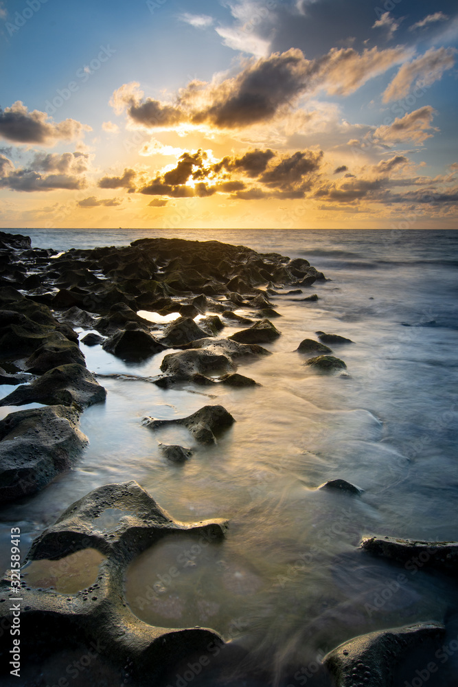 Surf flowing over rocks at sunrise on Singer Island Surf flowing over rocks at sunrise on Singer Island