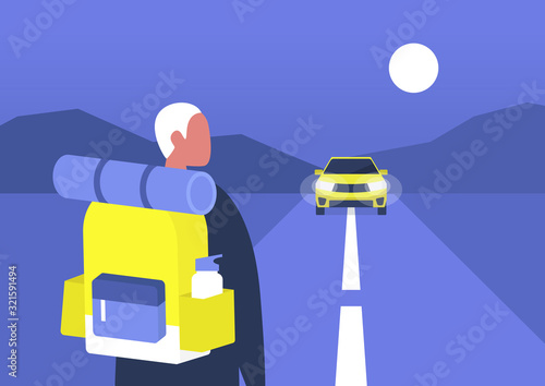Young male backpacker waiting a car to approach, hitchhiking, road trip adventures